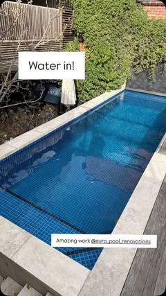 Completed tiled pool filled with water by Euro Pool Renovations