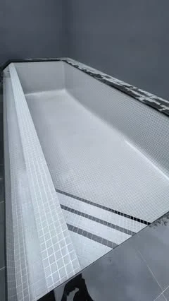 Fresh white mosaic pool tiling by Euro Pool Renovations
